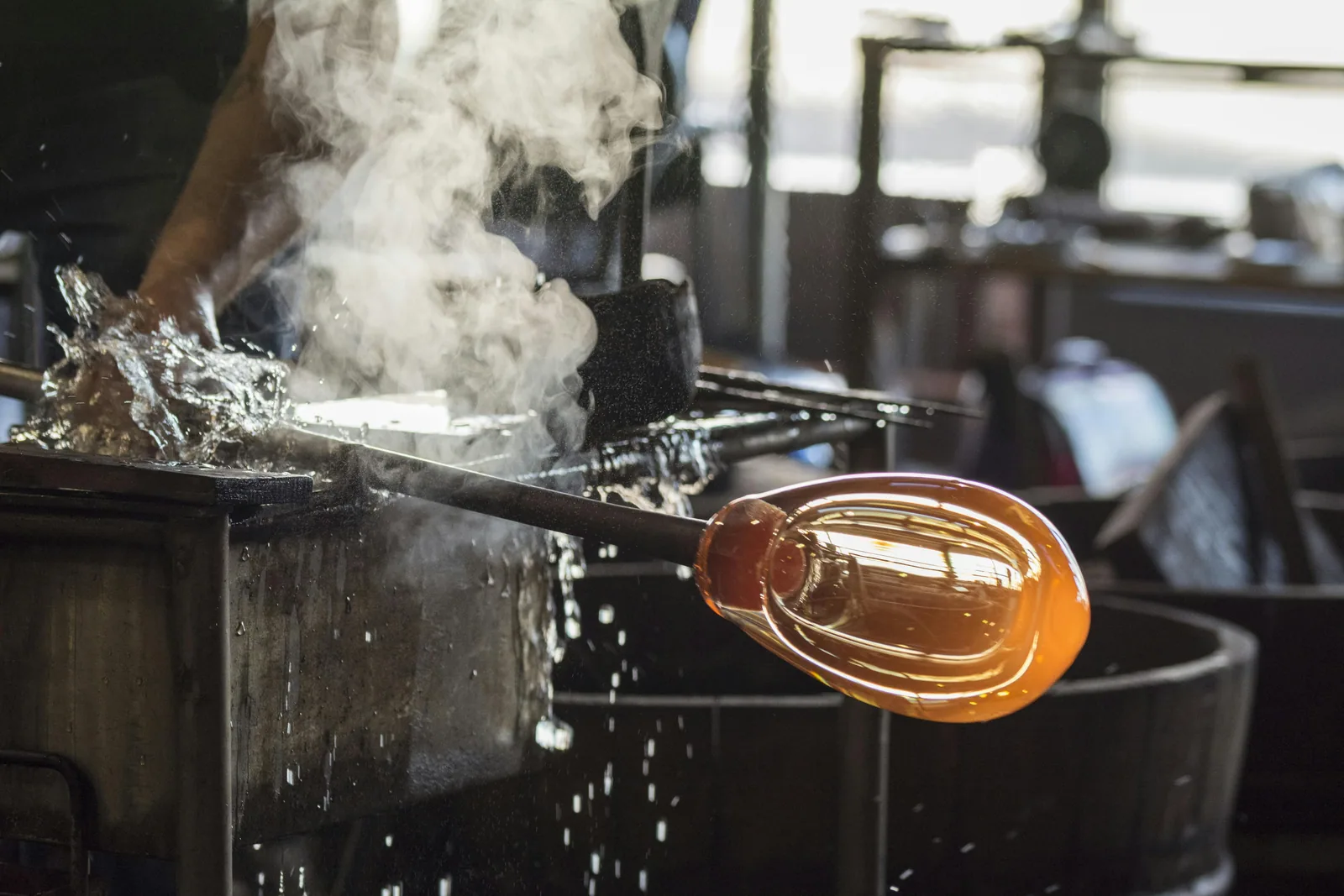 Glassblower gathering molten glass at a Firozabad furnace